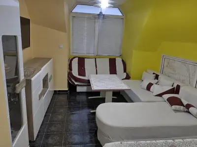 a living room with a couch and a table at Pomponi in Burgas City