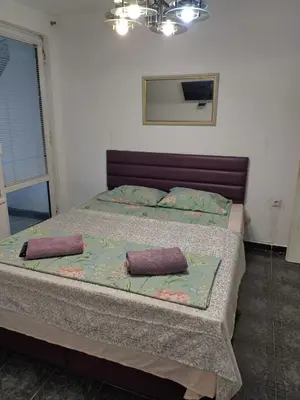a bedroom with a bed with two pillows on it at Pomponi in Burgas City