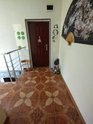 a hallway with a wooden floor and a door at Къща за гости Ками in Byala