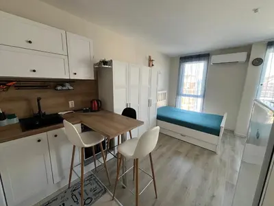 a kitchen with a table and chairs and a bed at Casa del Sol in Sunny Beach