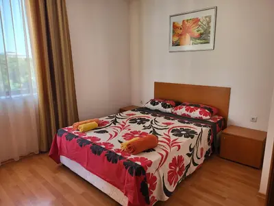 a bedroom with a bed with two pillows on it at Efir Sunny beach holiday apartment in Sunny Beach