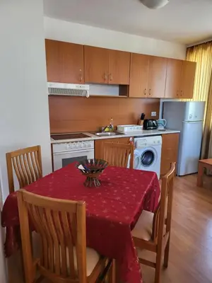 a kitchen with a table with a red table cloth at Efir Sunny beach holiday apartment in Sunny Beach