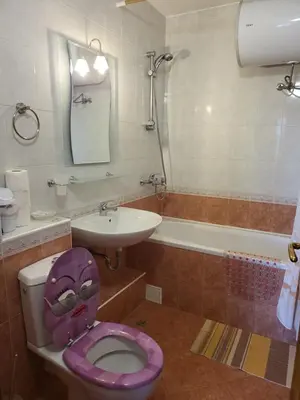 a bathroom with a purple toilet and a sink at Efir Sunny beach holiday apartment in Sunny Beach