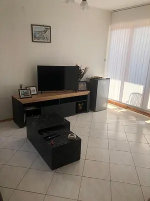 a living room with a flat screen tv and a table at 