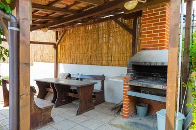 an outdoor kitchen with a table and an oven at 