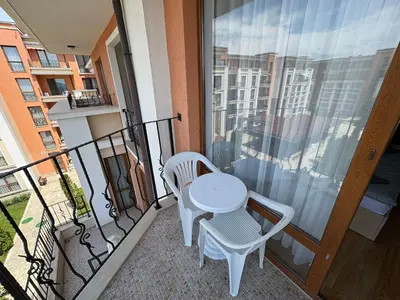 a balcony with a white table and chairs on it at Private Apartment 171 in Prestige Fort Beach Hotel in Sveti Vlas