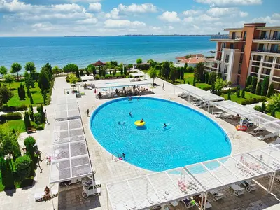 an overhead view of a large swimming pool next to the ocean at Private Apartment 171 in Prestige Fort Beach Hotel in Sveti Vlas
