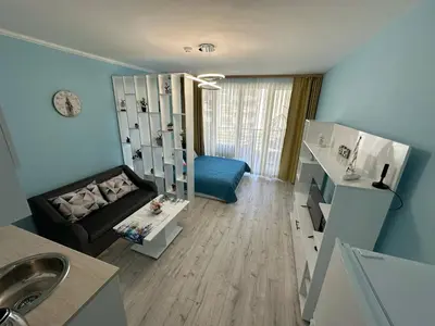 a bathroom with a living room with a couch at Nana Studio Sunny Beach in Sunny Beach