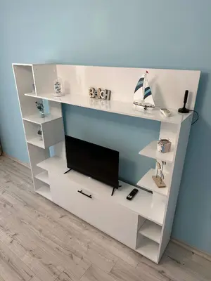 a white book shelf with a tv on it at Nana Studio Sunny Beach in Sunny Beach