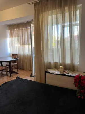 a bedroom with a bed and a window with a table at Kasandra in Byala