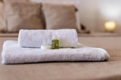 a towel and a bottle of soap on a bed at Sunny apartment in the center of Varna for 5Guests in Varna City