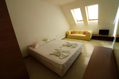 a small bedroom with a bed and a couch at Belle View - Menada Apartments in Sveti Vlas