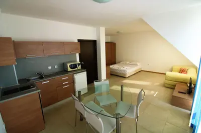 a kitchen with a glass table and chairs in a room at Belle View - Menada Apartments in Sveti Vlas