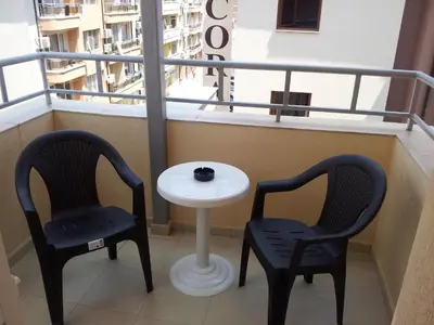 two chairs and a table on a balcony at Apartment Zlatina in Pomorie