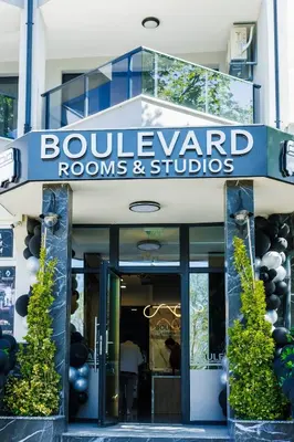 a building with a sign that reads boulevard rooms and studios at Boulevard Hotel in Aytos