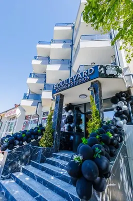 a building with blue and black balloons on the stairs at Boulevard Hotel in Aytos