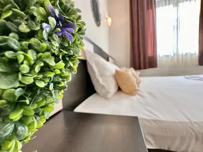 a bedroom with a bed with a large green wall at Menada Imperial Heights Apartments in Sunny Beach
