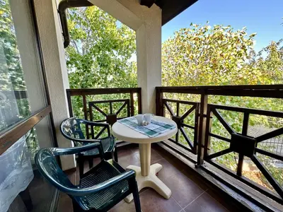 a balcony with a table and two chairs on a porch at Menada Imperial Heights Apartments in Sunny Beach