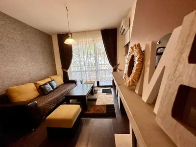 a living room with a couch and a table at Menada Imperial Heights Apartments in Sunny Beach