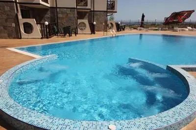 a large blue swimming pool in a building at Menada Imperial Heights Apartments in Sunny Beach