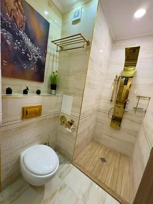 a bathroom with a toilet and a shower at Sea View Apartments Residence Лазурен бряг in Burgas City