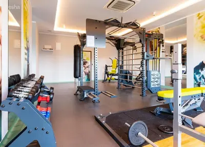 a gym with several treadmills and weights at Sea View Apartments Residence Лазурен бряг in Burgas City
