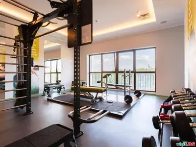 a gym with several treadmills and machines in a room at Sea View Apartments Residence Лазурен бряг in Burgas City