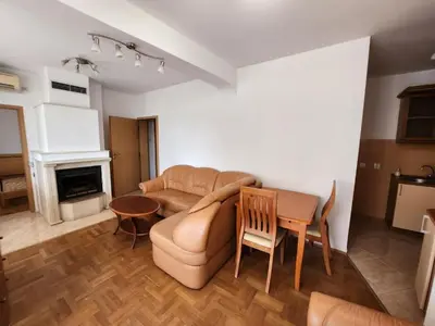 a living room with a couch and a table at Лукс Апартамент Лазур с безплатен паркинг in Pomorie