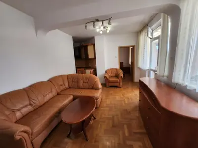 a living room with a couch and a table at Лукс Апартамент Лазур с безплатен паркинг in Pomorie