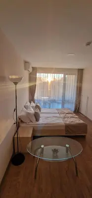 a bedroom with a bed and a glass table at Premier Fort Beach Hotel in Sveti Vlas