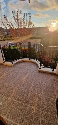 a balcony with a fence and a brick walkway at Premier Fort Beach Hotel in Sveti Vlas