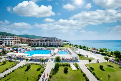 an aerial view of a resort with a pool and the ocean at Premier Fort Beach Apartment with Pool & Sea View in Sveti Vlas