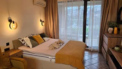 a bedroom with a bed with two stuffed animals on it at Vladan apartments in Sozopol
