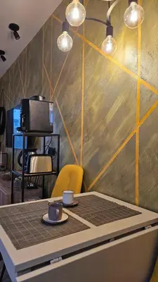 a table with two cups of coffee on top of it at Vladan apartments in Sozopol