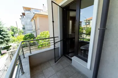 a balcony with glass doors on a building at GGeorgi Sarafovo in Burgas City