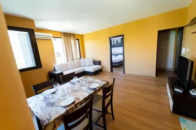a dining room with a table and a living room at GGeorgi Sarafovo in Burgas City