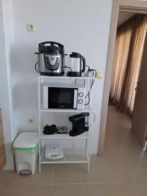 a stove with pots and pans on top of it at Condo Santosha on the beach in Pomorie