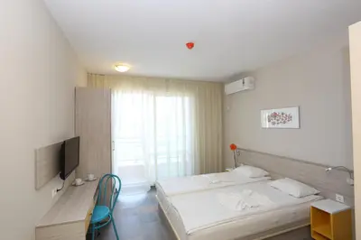 a bedroom with two beds and a television in it at Sunny Residence complex in Sunny Beach