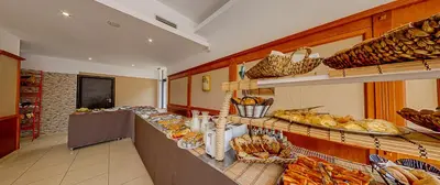 a bakery with a bunch of bread and pastries at Sunny Residence complex in Sunny Beach
