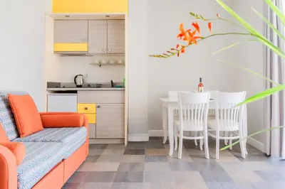a living room with a couch and a table and chairs at Sunny Residence complex in Sunny Beach