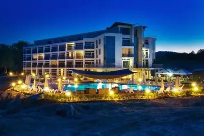 a large building with a swimming pool at night at STUDIO 46 South Pearl Homes in Sozopol
