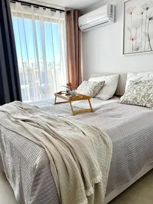 a bedroom with a bed with a table on it at Polarstar Apartment in Sveti Vlas