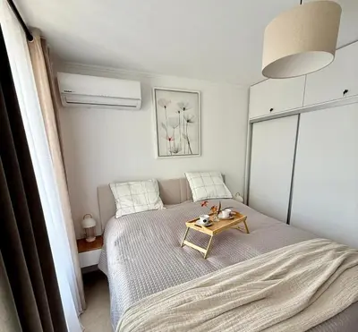 a bedroom with a bed with a table on it at Polarstar Apartment in Sveti Vlas