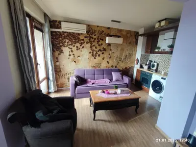 a living room with a purple couch and a coffee table at Central View Burgas in Burgas City