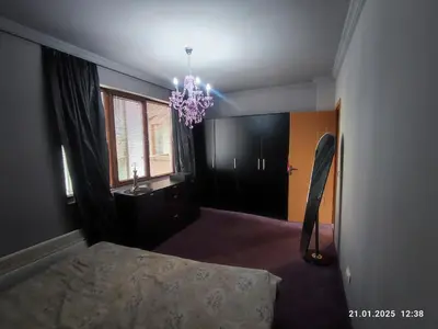 a bedroom with a bed and a chandelier at Central View Burgas in Burgas City