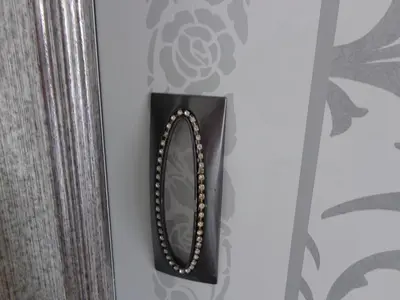 a mirror hanging on a wall next to a curtain at Apartment Alyosha in Burgas City