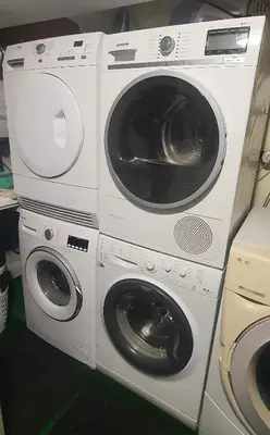 two washing machines and a dryer sitting next to each other at AT Home in Burgas City