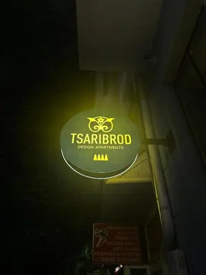 a sign for a t restaurant on the side of a building at Tsaribrod Design Apartments in Varna City