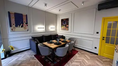 a dining room with a table and chairs at Tsaribrod Design Apartments in Varna City