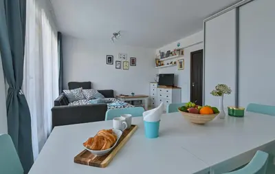 a living room with a table with a bowl of croissants at Via Sunride 1 - Maisonette Apartment by the sea in Sozopol